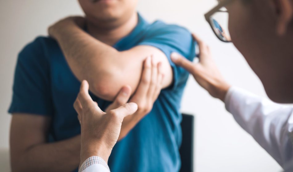 Doctor examining elbow pain